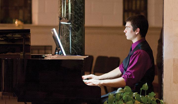 Student playing piano in Chapel
